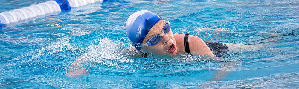 swimmer in action in pool swimming lane